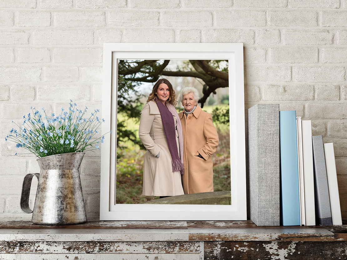 Edinburgh Portrait Photographers -  photo of mum and daughter on shelf with books and flowers
