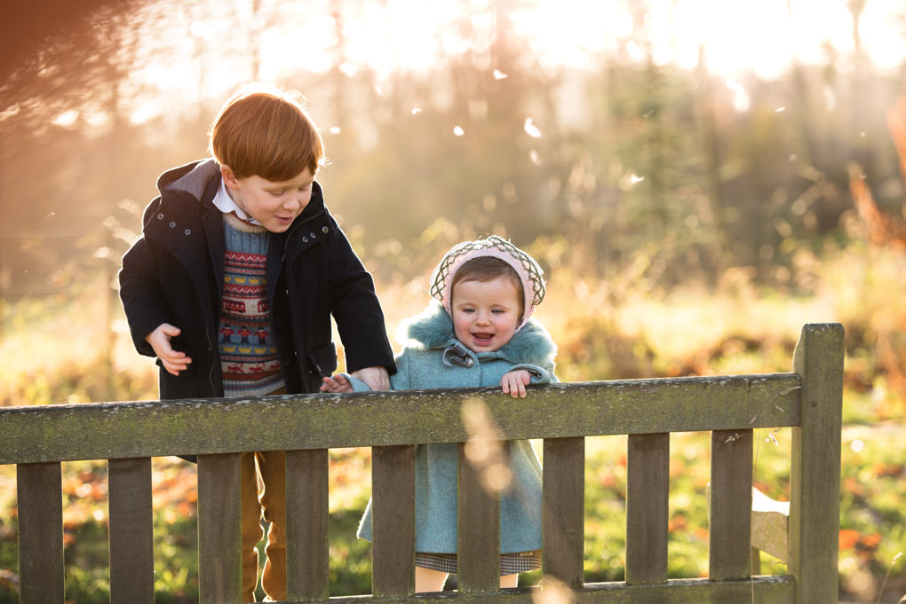 Family photographer Edinburgh - Lauriston Castle - little boy and girl on bench in autumn sun