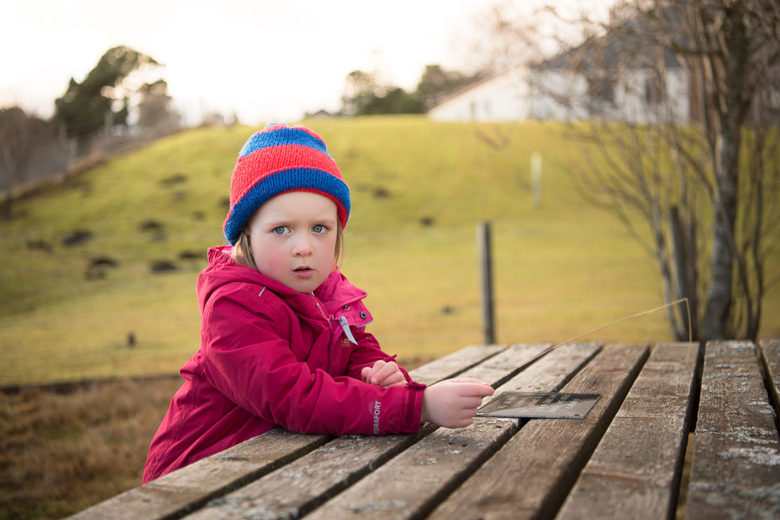 stop annoying your children with your camera - Glebe Lochans, Kingussie - little girl sitting at picnic bench