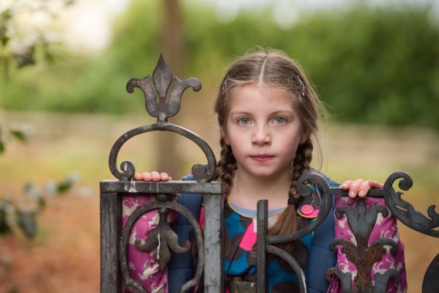Edinburgh portrait photographer - little girl standing behind wrought iron gate