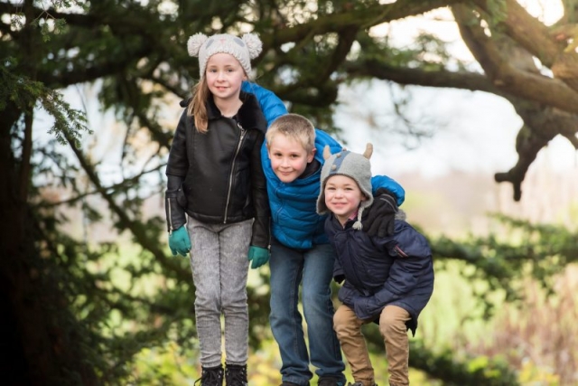 Family photography Edinburgh - three children in front of yew tree
