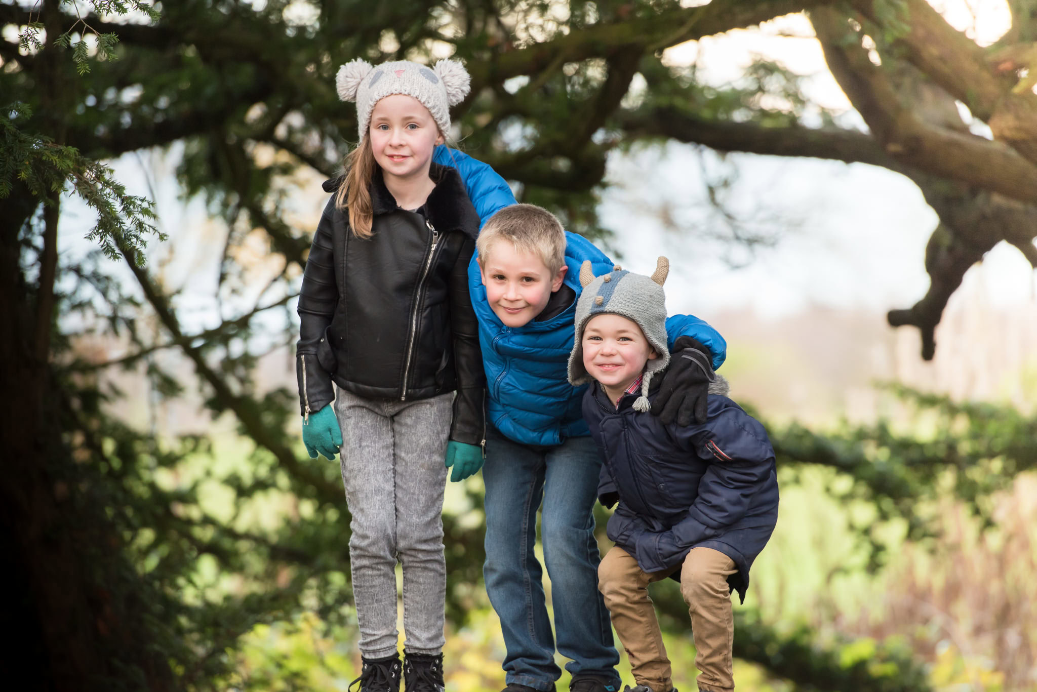 Edinburgh family photographer - girl and two boys in front of hazel tree at Lauriston Castle