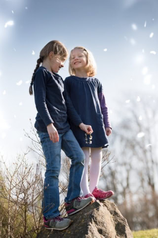 little girls standing on a rock