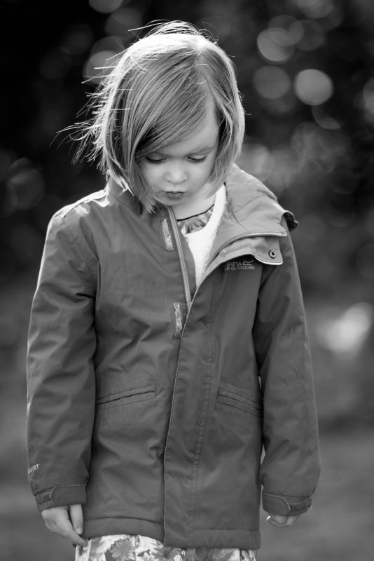 Don't put off getting family portraits taken - little girl looking down and pouting
