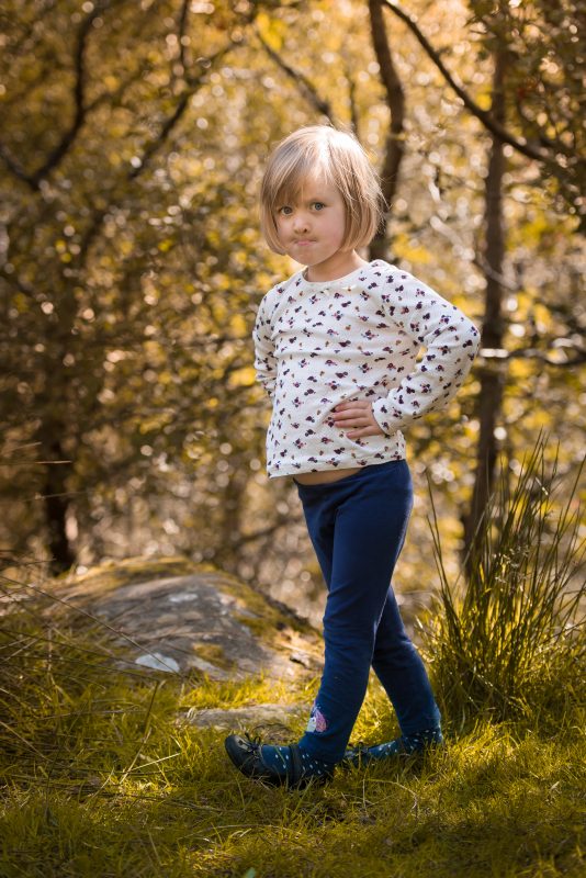 Portrait Photographer Edinburgh - forgot you had another kid - small girl standing in woods looking belligerent