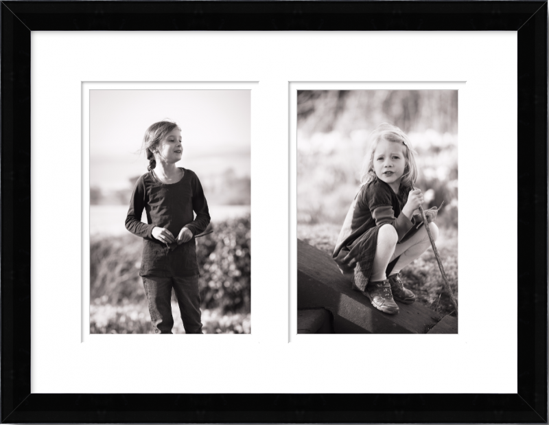 Two black and white portrait photographs of two little girls in a black frame
