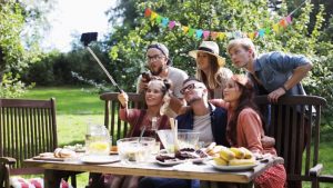 Edinburgh Photographer - people at dinner outdoors taking photo on smartphone with selfie stick