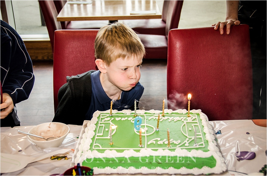 Edinburgh family photography of little boy blowing out candles on birthday cake