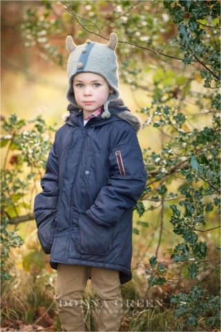 Edinburgh Portrait POhotogaraphers - Little boy in blue coat and grey hat standing in front of holly bush
