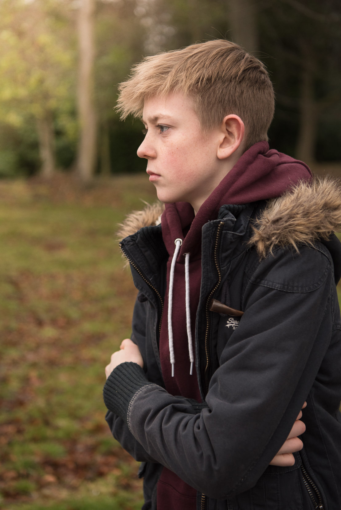 When to stop photographing a child - teenage boy in the woods facing looking into distance
