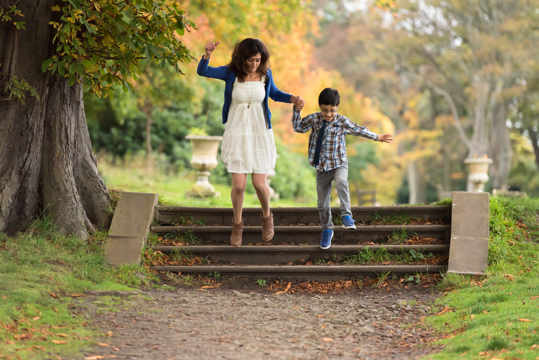 Family photographer Edinburgh - mum and little boy jumping off steps at Lauriston Castle