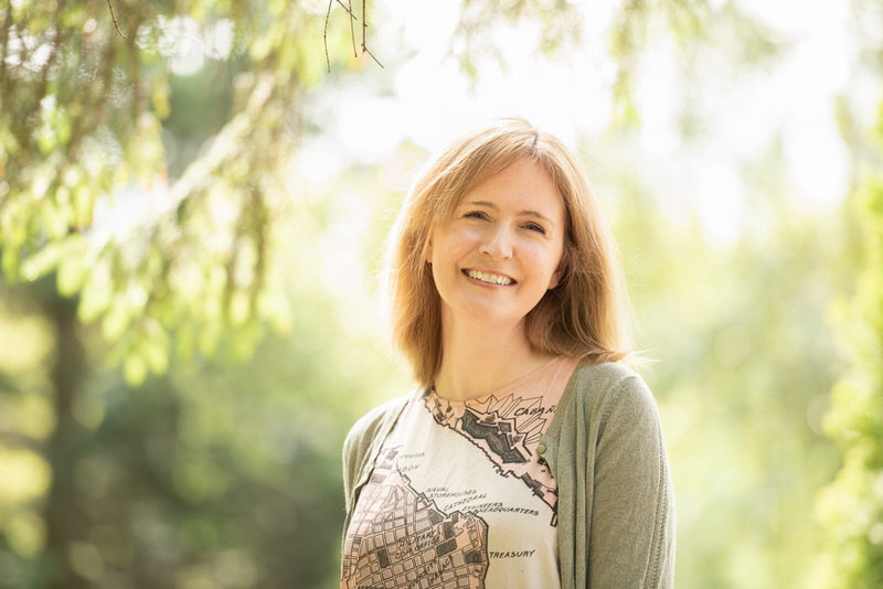 Personal Branding Photographer Edinburgh - headshot of red haired woman against trees