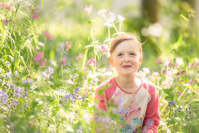 Family photographer Edinburgh - little girl sitting in spring flowers