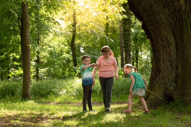 natural photos of children - little boy and girls playing in woods