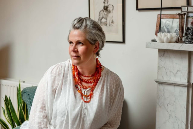 Personal branding shoot in Edinburgh, Scotland - woman with grey hair, orange necklace, and white blouse