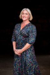 Brand photography Edinburgh Scotland and headshots - portrait of woman with blond hair against black background