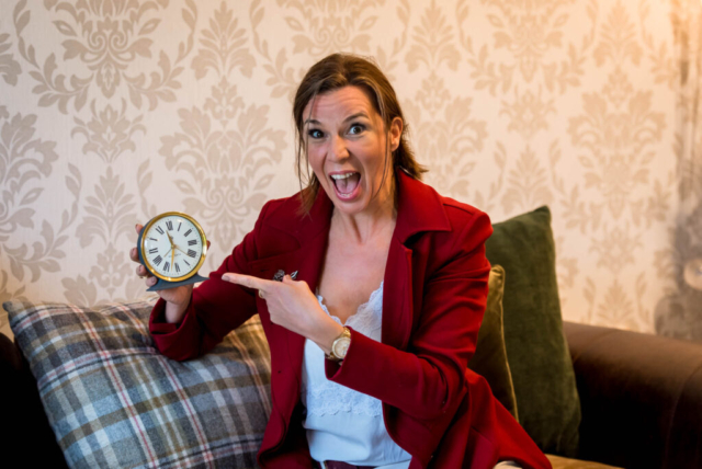 Personal branding photoshoot for business coach in Edinburgh Scotland - woman pointing at clock