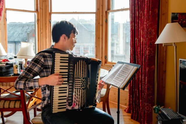 Brand photographer headshot of accordionist musician in Edinburgh, Scotland
