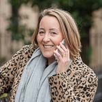 Niki Hutchison brand marketing strategist on phone