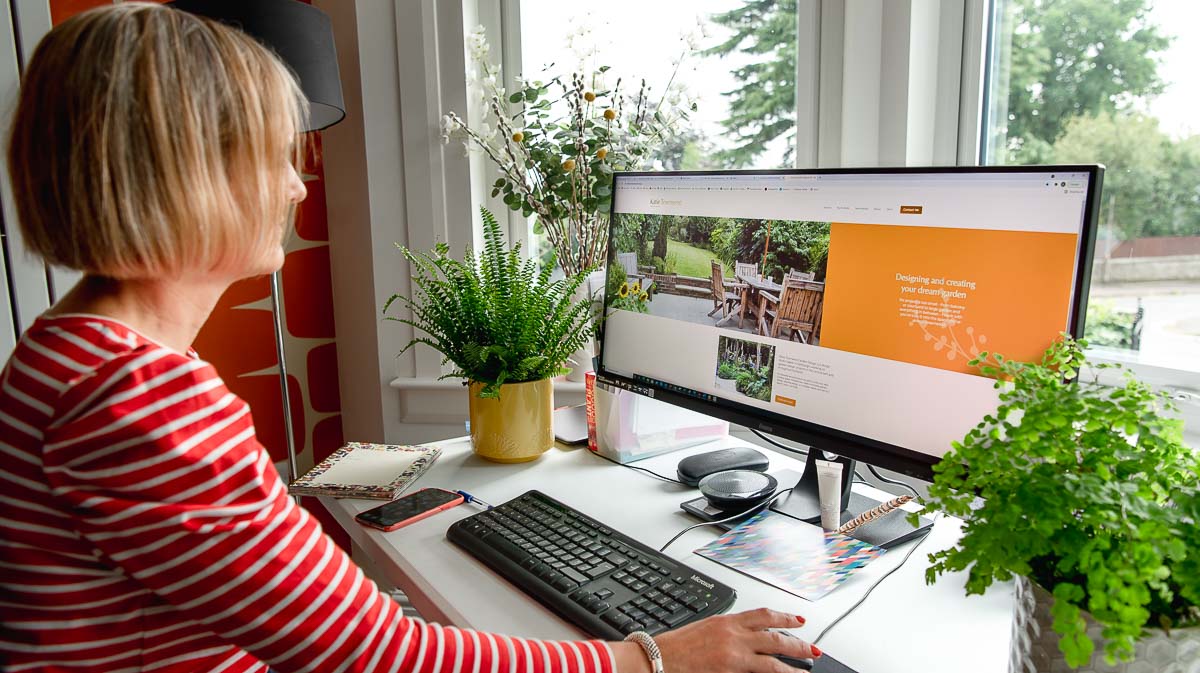 Woman at wide computer screen