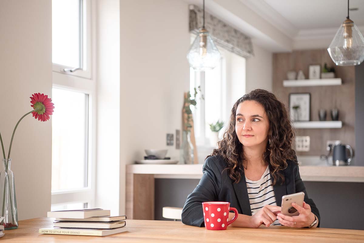 Woman sitting at table looking out of window