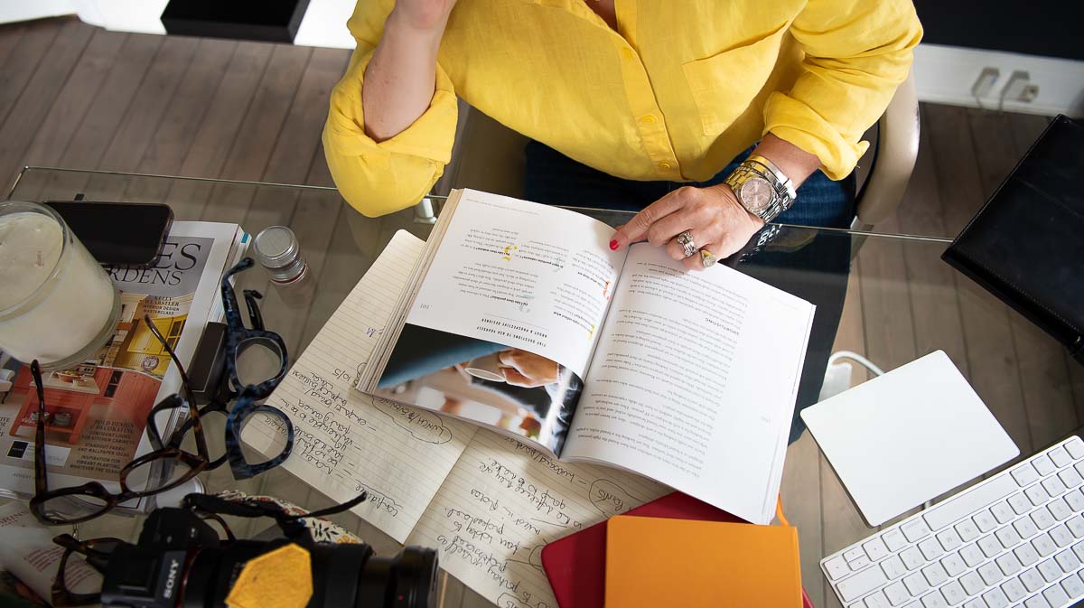 Woman reading book at desk