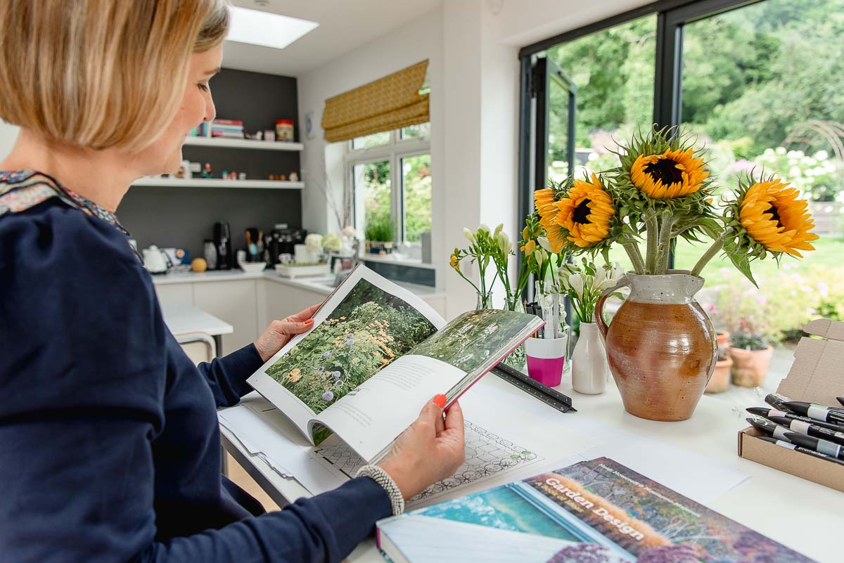 Woman reading gardening magazine