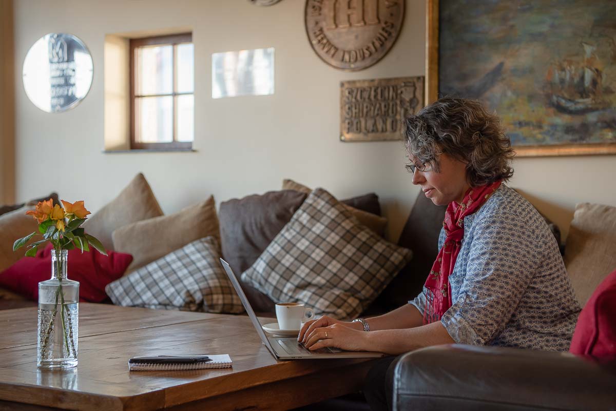 Woman sitting in cafe with laptop