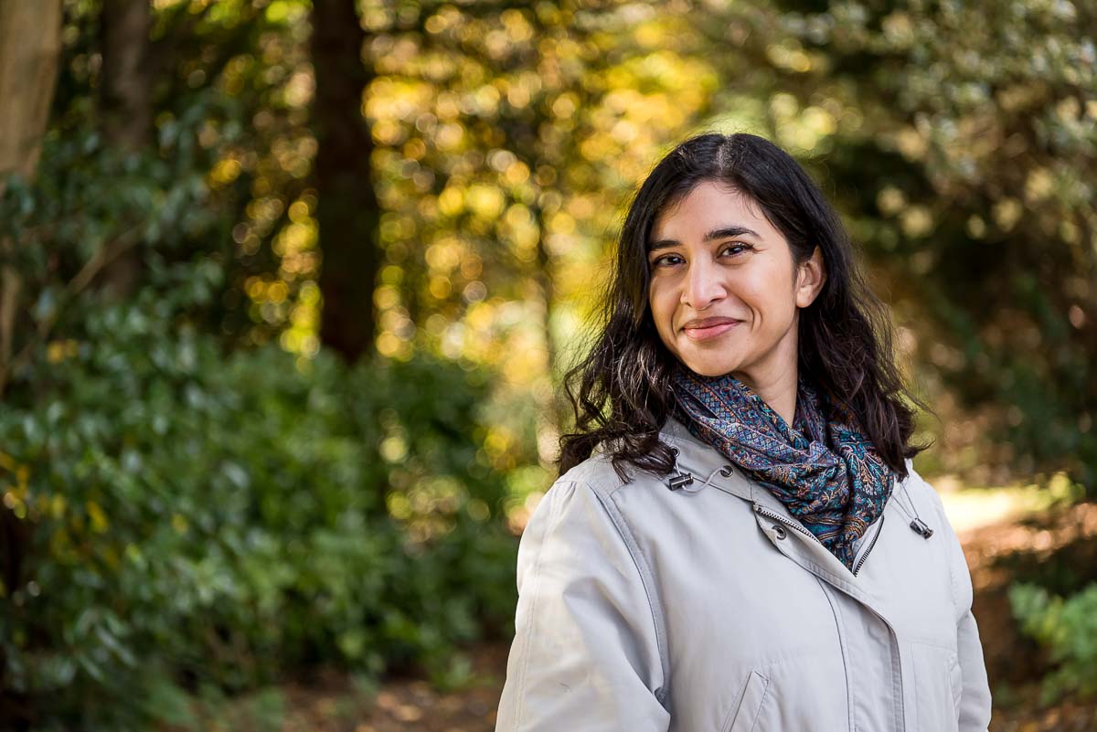 Woman with long black hair in woods