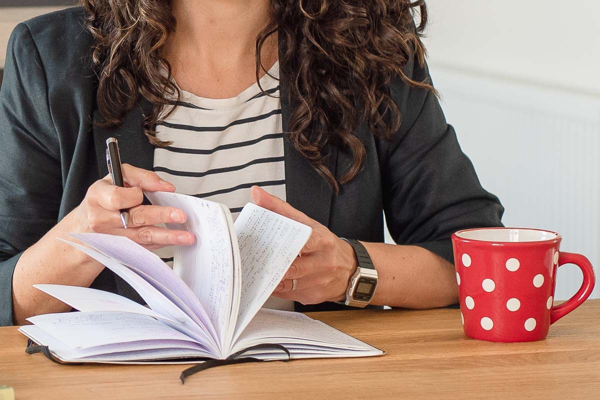 Woman flicking pages in notebook