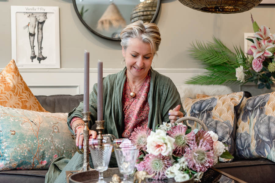 Brand photography photo shoot in Edinburgh Scotland for female small business owner - woman sitting on couch pouring drink