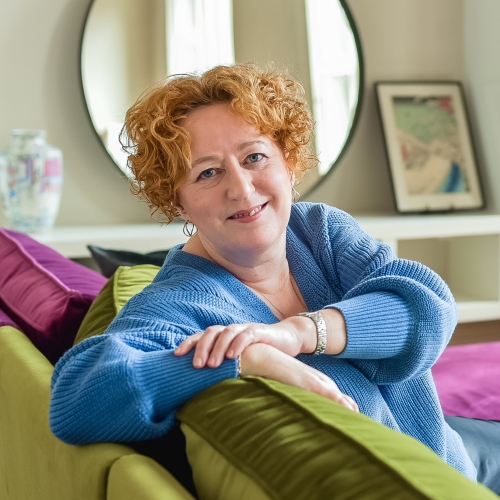 Brand photographer Edinburgh Scotland - headshots photograph of woman with red hair sitting on couch