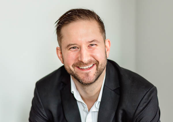 How to take business photos for the real estate and property industry - sharp, well lit headshot of man in his 30s with short brown hair and a beard in a suit in Edinburgh, Scotland
