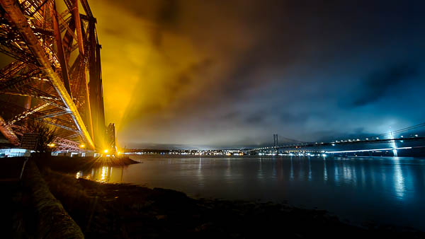 How to take business photos for the hospitality and travel industry - image of the Forth Rail Bridge in Edinburgh, Scotland, lit up at night