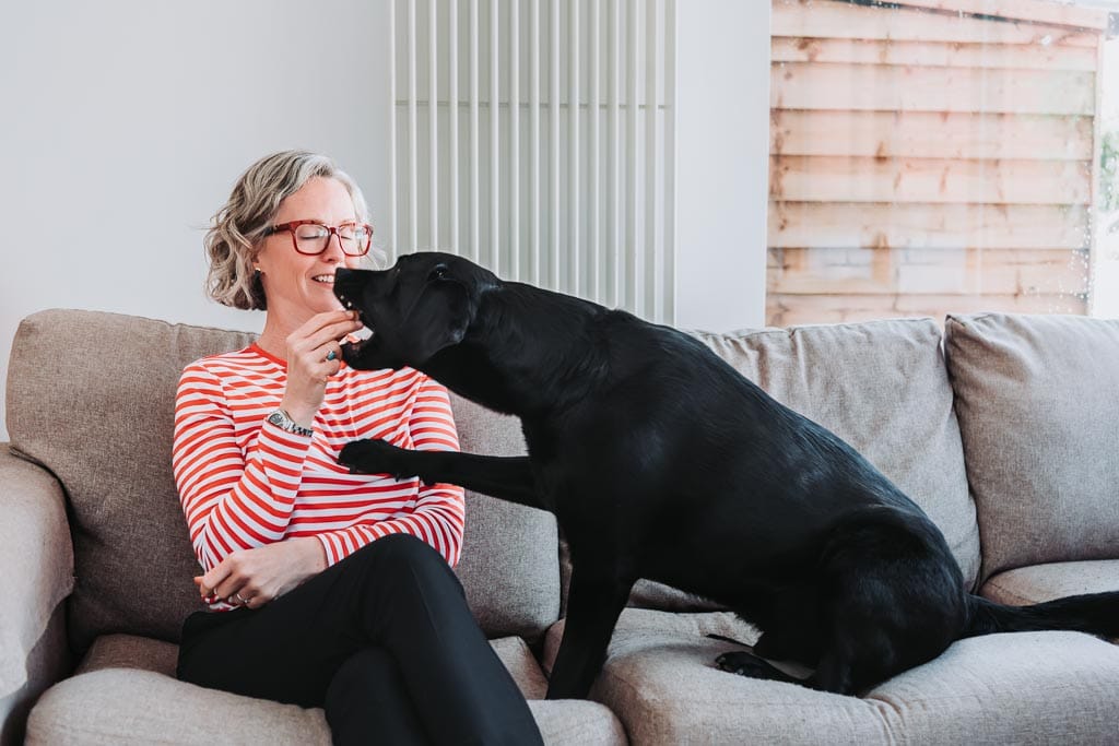 Executive assistant Sarah Whigham with her black Labrador Henry during her brand photography session in Edinburgh, Scotland