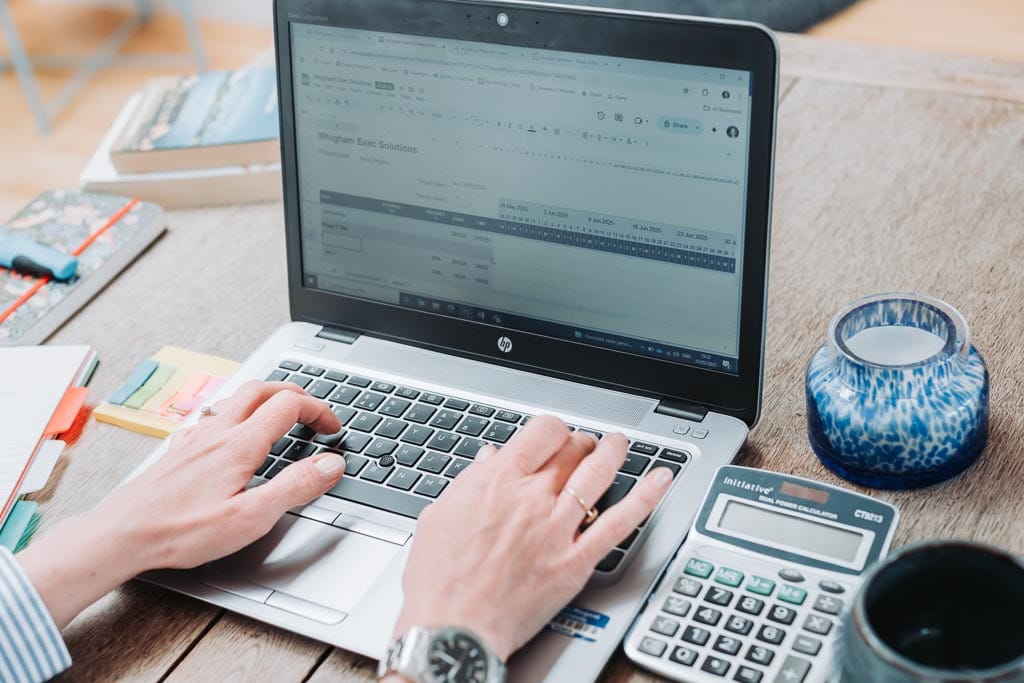 Brand photography session for executive coach in Edinburgh, Scotland, showing working on laptop
