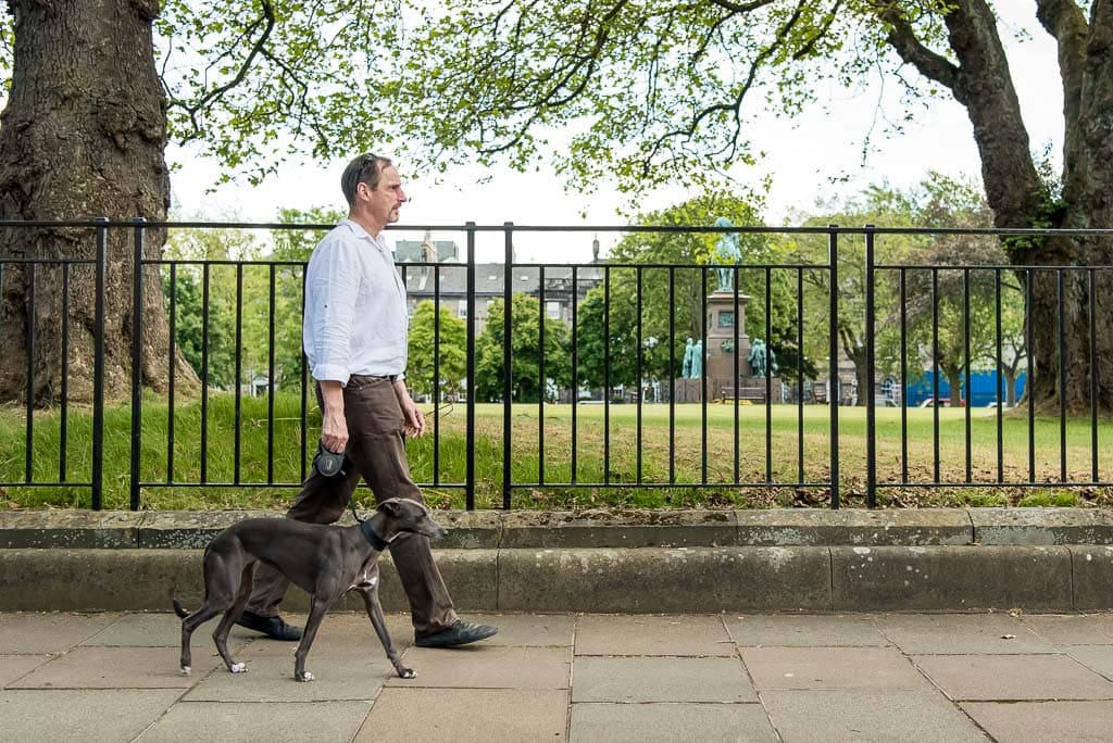 Brand photoshoot location in Edinburgh, Scotland, showing a small business owner with his whippet dog photographed in a calm city setting.