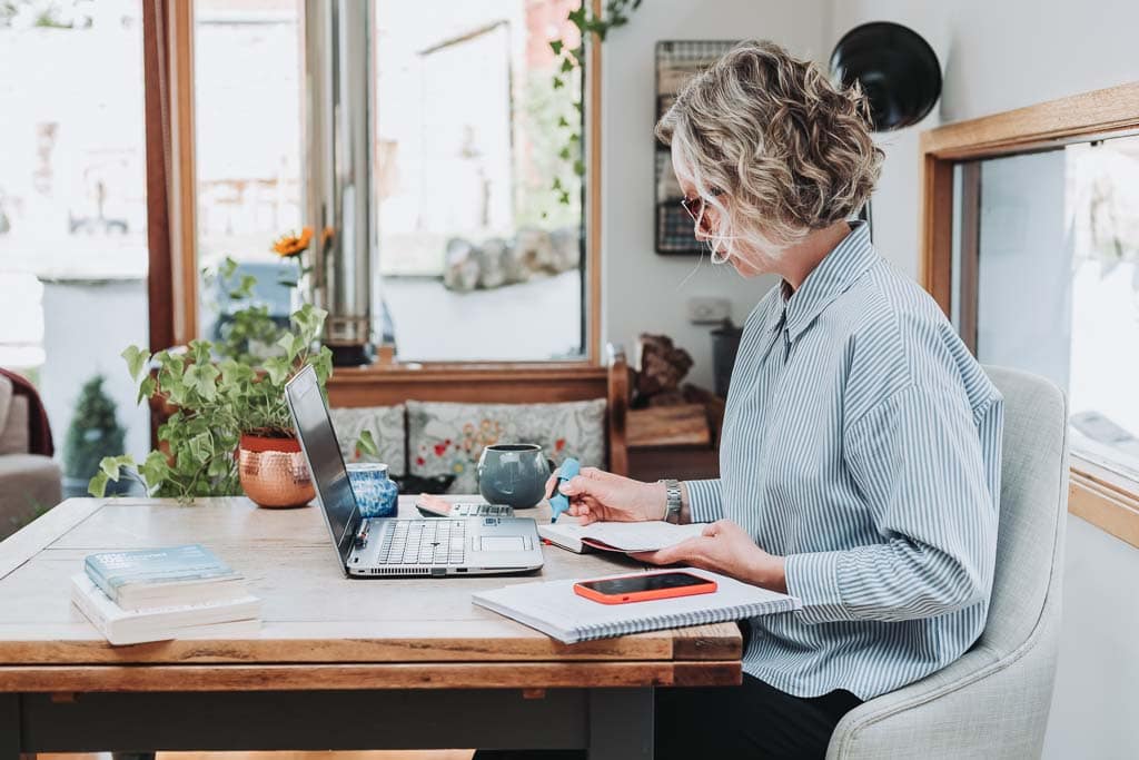 Business owner working at her laptop during a one hour brand photoshoot in Edinburgh, Scotland with brand photographer Donna Green