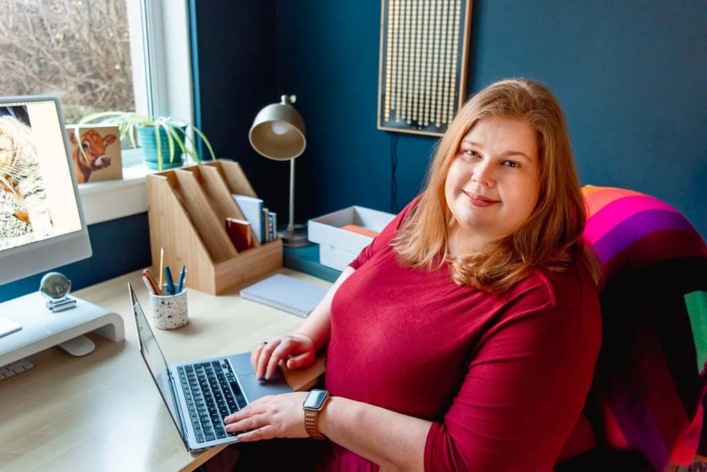 Personal brand photography Edinburgh – business owner working at desk with laptop in natural light workspace
