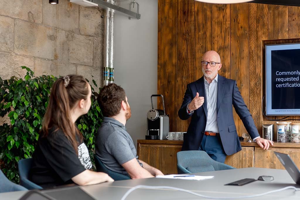 Independent professional presenting to clients in a meeting in Edinburgh, Scotland, showing real working interaction and business context beyond a simple headshot