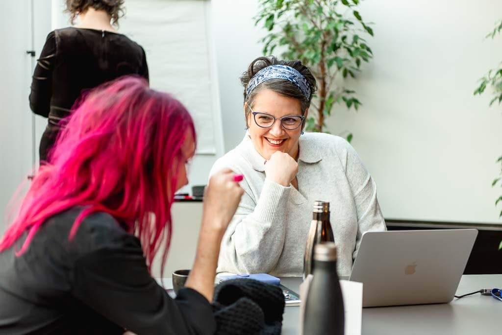 Brand photography showing how to look professional online without looking corporate - Independent professionals in Edinburgh, Scotland, in a relaxed meeting, showing a credible but non-corporate business environment