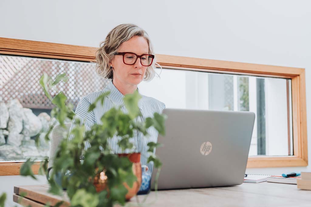 Independent professional working in Edinburgh, Scotland on a laptop in a natural setting, showing a credible but non-corporate online presence