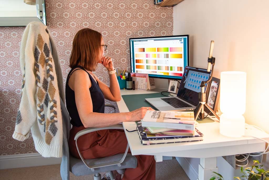 Full day brand photoshoot in Edinburgh and across Scotland for coaches, consultants, independent professionals, and service-based businesses - Graphic designer reviewing colour palettes at her desk in her home office