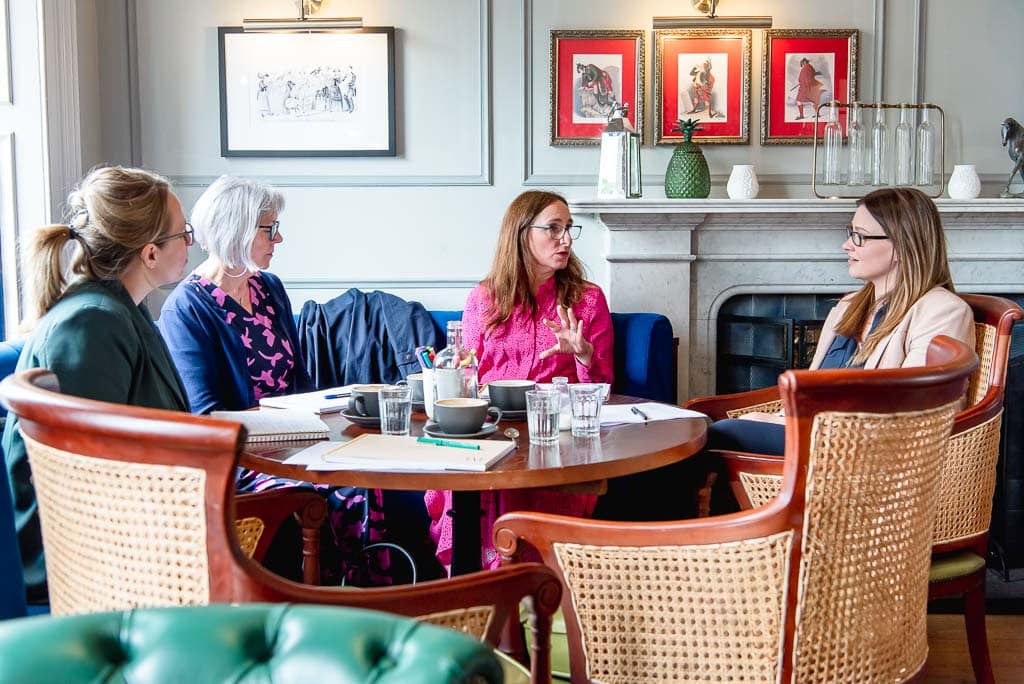 One hour brand photoshoot in Edinburgh for service-based independent professionals, coaches, and consultants across Scotland - coach shown leading a workshop in an indoor setting