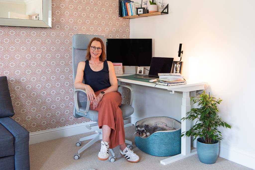 Graphic designer Karen Bennett sitting in her home office with her dog during a brand photography session with Edinburgh brand photographer Donna Green in Scotland