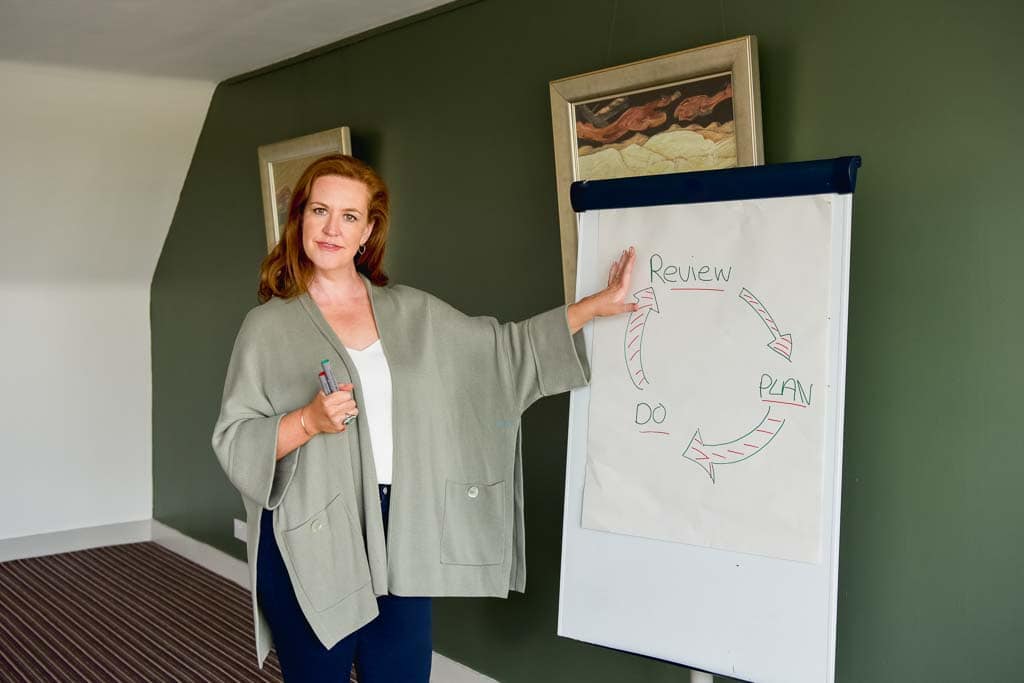 Brand photography in Glasgow showing leadership consultant Yvonne Anderson presenting beside a flipchart