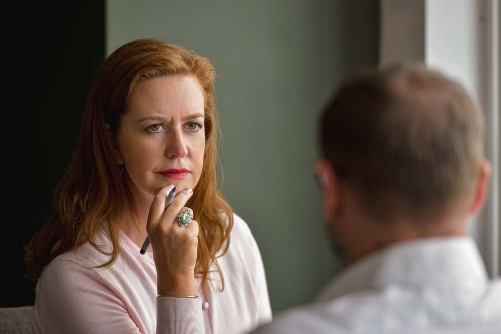 Glasgow business photography showing consultant Yvonne Anderson listening attentively during a professional discussion