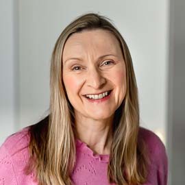Brand photographer Edinburgh business portrait photoshoot for copywriter - headshot of woman in pink jumper